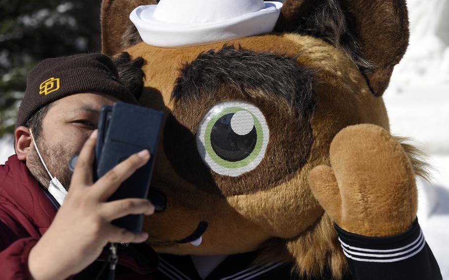 Yoko-Pon, the mascot for Yokosuka Naval Base, Japan, stops for a selfie at the Sapporo Snow Festival in Hokkaido, Feb. 5, 2024. 