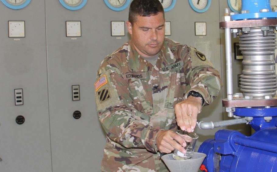Col. Jason Edwards, then-U.S. Army Garrison Rheinland-Pfalz commander, takes a water sample at the military’s Pfeffelbach Water Treatment Plant near Baumholder, Germany, in 2019. The Pfeffelbach plant operates independently from the German municipal water supply. Local officials rescinded a boil water notice for most people living off-post near Baumholder on April 19, 2022. 