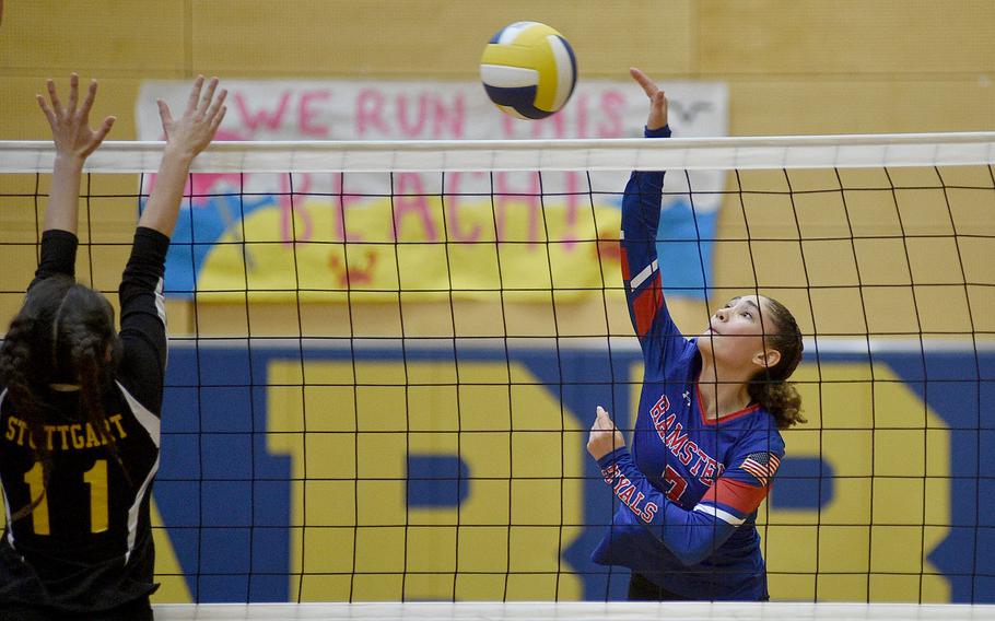 Ramstein sophomore Amayah Payton spikes the ball as Stuttgart's Mia Snyder during a match on Sept. 9, 2023, at Wiesbaden High School in Wiesbaden, Germany.