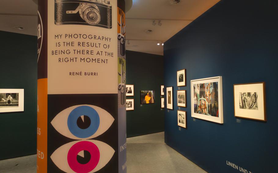 A sign in a gallery space full of street photography says, “My photography is the result of being there at the right moment -  René Burri.” 