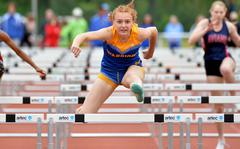 Wiesbaden’s Ava Stout on her way to winning the 100-meter hurdles race in record time at the DODEA-Europe track and field championships in Kaiserslautern, Germany, May 20, 2023, A day after breaking Tiffany Heard’s 13-year-old record, Stout broke her own record, running 14.58 seconds for the new record.