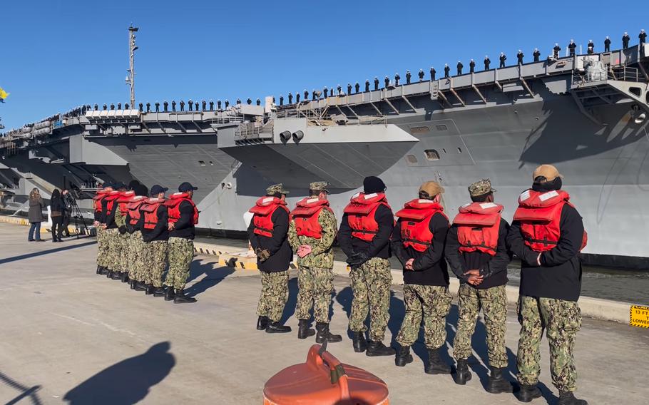 In this screenshot from video, sailors man the rails as the USS Gerald R. Ford pulls into its homeport at Naval Station Norfolk, Va., Wednesday, Jan. 17, 2024. The Navy’s newest aircraft carrier returned home following an eight-month deployment — the carrier’s first combat deployment — assisting U.S. efforts to contain the Israel-Hamas war.