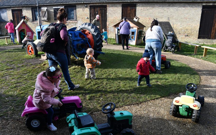 Families play in a playground area with re-imagined farm equipment at South Angle Farm Park, Feb. 15, 2023. Large playgrounds are scattered throughout the farm in between the animal interaction exhibits. 