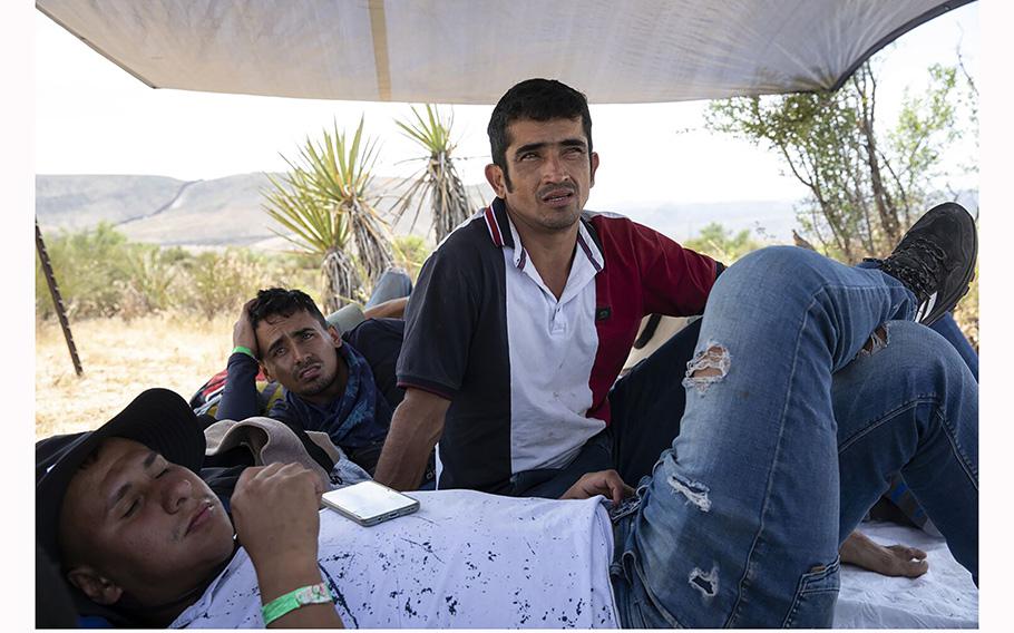 A group of Colombians wait in a holding area to be processed by the Border Patrol agents on Monday, May 15, 2023, in Jacumba, California. 