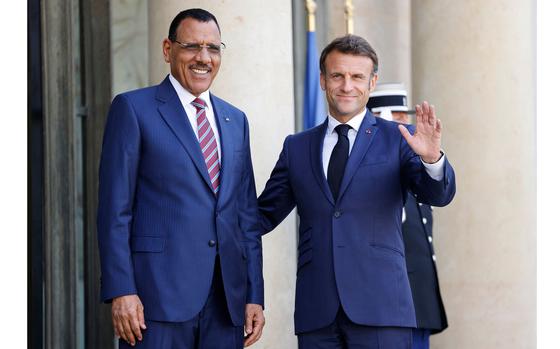 French President Emmanuel Macron, right, greets Niger's President Mohamed Bazoum as he arrives for a meeting at the Elysee Palace, amid the New Global Financial Pact Summit in Paris on June 23, 2023. (Ludovic Marin/AFP/Getty Images/TNS)