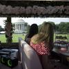 People look out a tour bus window at the Jefferson Memorial in Washington.