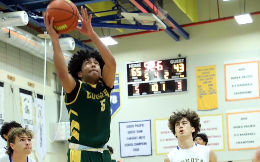 Edgren's Gordon Tsutomo puts up a shot ahead of Yokota's Nathan Frost and Kicoh Guenther.