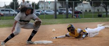 Kadena baserunner Adrian Wilson slides into third base just ahead of the throw to Kubasaki's Nicholaz Aguirre during Monday's DODEA-Okinawa baseball game. The Panthers won a walk-off 6-5 victory to level the season series at 5-5.