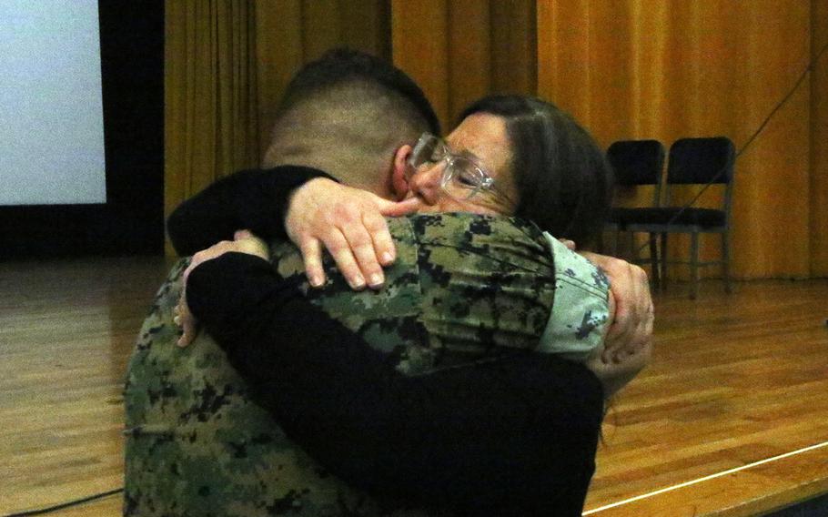 Marine Sgt. Jean-Keith Buzard of the 3rd Maintenance Battalion hugs Jessica Niss, who lost her Marine son to an Okinawa rip current, followering her water-safety presentation at Camp Foster, May 24, 2023.