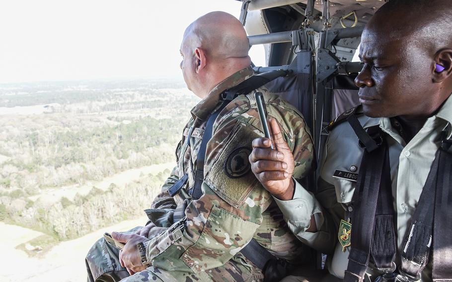 U.S. Air Force Chief Master Sgt. Jason P. Colon, left, looks out over Fort Benning, Ga., during a ride on a UH-60 Black Hawk helicopter March 22, 2022, during the U.S. Army’s African Land Forces Summit. Colon, the senior enlisted leader for the U.S.’s Combined Joint Task Force-Horn of Africa based in Djibouti accompanied military leaders from some 40 African nations for the seminar meant to tighten relations with partner and allied countries on the Continent.