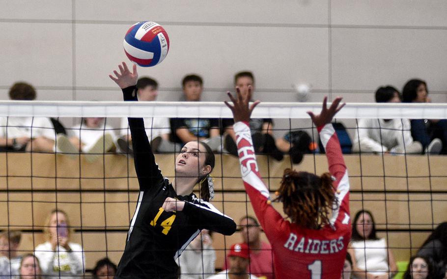 Stuttgart middle hitter Hannah Homes spikes the ball as Kaiserslautern middle hitter Moriah Deane goes for the block during a scrimmage at Ramstein High School on Sept. 1, 2023, on Ramstein Air Base, Germany.