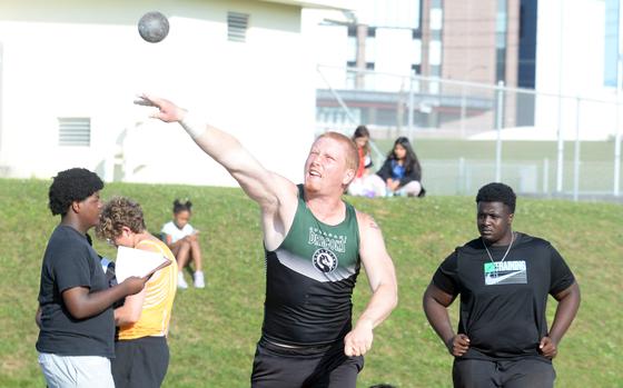 Kubasaki's Brennan Hall captures the shot put.