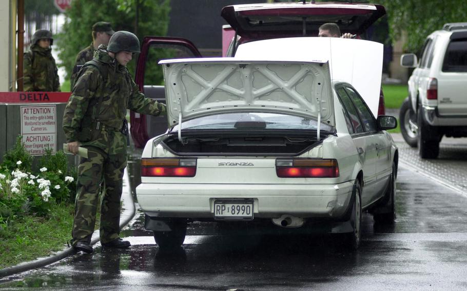 Members of the 469th Security Forces Flight search a vehicle at Rhein-Main Air Base, Germany on Sept. 12, 2001. Every vehicle entering the base was inspected as U.S. forces worldwide remained at Threat Condition Delta, the highest level of alert, after the 9/11 terrorist attacks on New York and Washington, D.C.  Many of the security measures implemented in 2001 are still in place today.