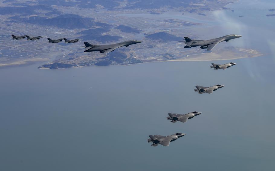 Two U.S. Air Force B-1B bombers, top center, South Korean Air Force F-35 fighter jets and US Air Force F-16 fighter jets, left, fly over South Korea Peninsula during a joint air drill in South Korea, Saturday, Nov. 19, 2022. 
