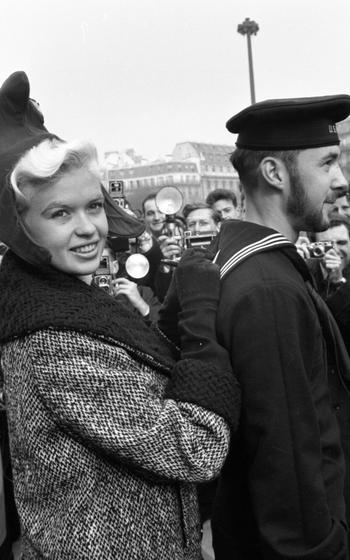 Jayne Mansfield signs autographs for gathered fans and photographers on the back of an unidentified U.S. sailor in front of the Musée de l’Homme (Museum of Mankind) Oct. 4, 1957. Wearing a Phrygian cap pinned with a tricolor cockade, a symbol of the French revolution, the actress — in Paris for the French premier of her latest film “Will Success Spoil Rock Hunter?” — will fly to Frankfurt, Germany, in the afternoon for a whirlwind visit of a number U.S. military installations. 