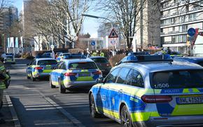 Police vehicles are parked on the grounds of Heidelberg University in Heidelberg, Germany, Monday, Jan. 24, 2022.