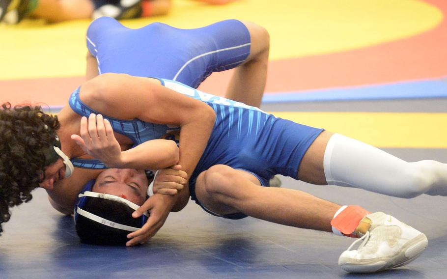 Kubasaki’s Godfrey Wray gains the upper hand on St. Mary’s Tatsuya Aoki at 129 pounds during Tuesday’s Azabu Ward year-end international open wrestling tournament. Aguirre pinned Aoki in 30 seconds and came in second in the division.