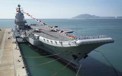 FILE - In this Dec. 17, 2019, file photo provided by Xinhua News Agency, the Shandong aircraft carrier is docked at a naval port in Sanya in southern China's Hainan Province. Taiwan's defense ministry said Saturday that it detected three ships from the Chinese navy, one of which was the Shandong aircraft carrier, passing through the Taiwan Strait. (Li Gang/Xinhua via AP, File)