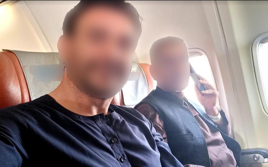 Mohammad, left, a Special Immigrant Visa applicant, takes a selfie on the flight that Task Force Argo, a private group set up and led by military veterans, chartered to evacuate him and other Afghans from Afghanistan in October 2021, weeks after the U.S. airlift out of Kabul had ended. Argo uses donations to house Afghan allies and U.S. citizens in safe houses while they wait for evacuation flights.