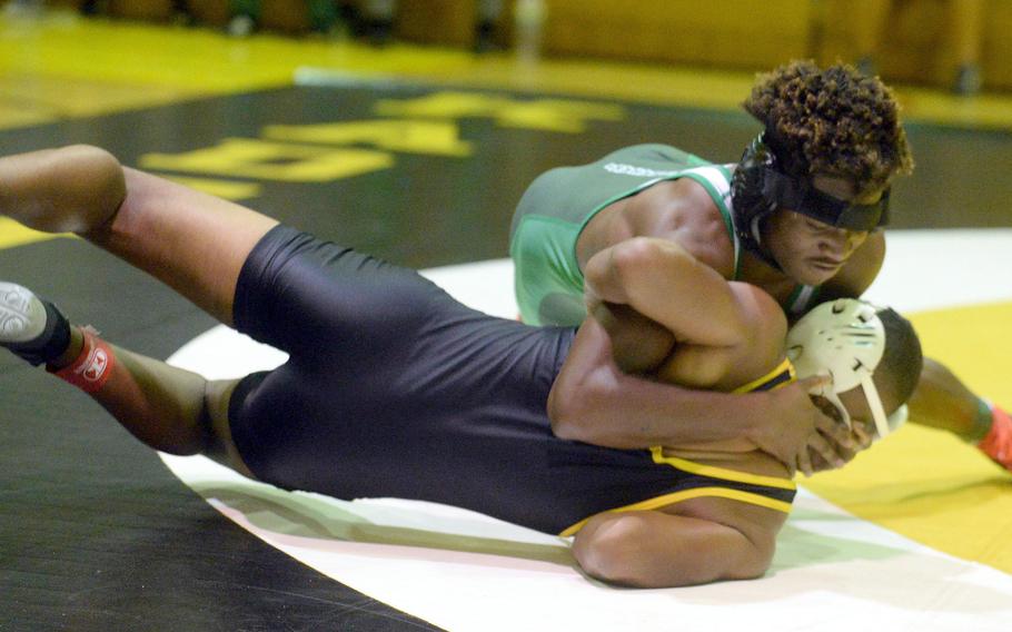 Kubasaki's Godfrey Wray gains the upper hand on Kadena's James Kinney at 148 pounds during Wednesday's Okinawa wrestling dual meet. Wray won by 10-1 decision, but the Panthers won the meet 30-28.