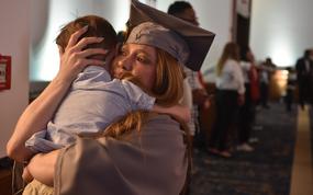 Marlee DaBrowski, an Army spouse, tearfully hugs her son, John, 4, after receiving her associate’s degree in general studies at the University of Maryland Global Campus Europe commencement ceremony on Saturday, April 27, 2024, at Ramstein Air Base, Germany. About 250 graduates walked the stage, out of a class of more than 1,100 who earned degrees from Europe, North Africa and the Middle East.
