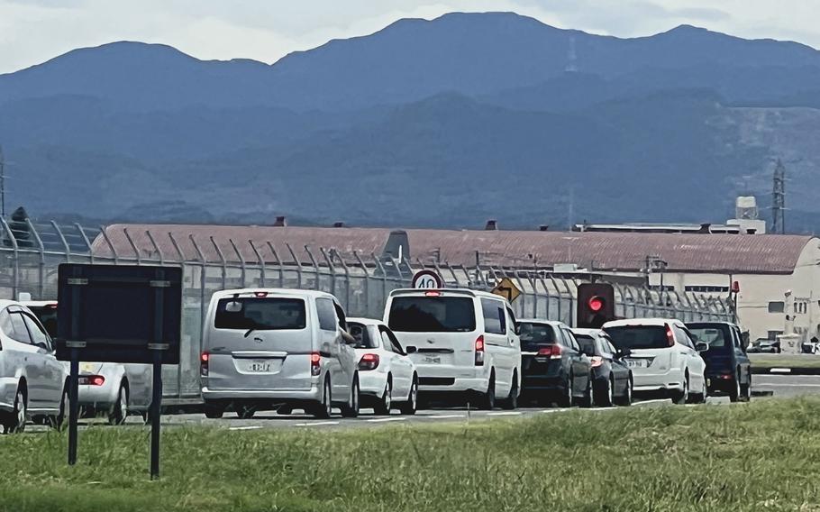 Traffic waits at a light to cross the runway south overrun at Yokota Air Base, Japan, on Sept. 21, 2023.