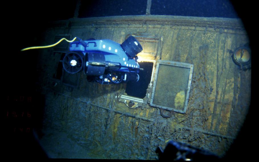 In this image provided by the Woods Hole Oceanographic Institution, an underwater remote vehicle examines an open window of the Titanic 12,500 feet below the surface of the ocean, 400 miles off the coast of Newfoundland, Canada, in 1986. 