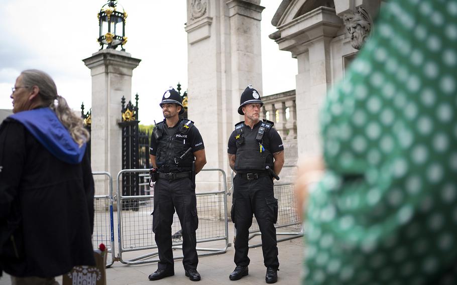 Two police officers from West Mercia, about three hours from London, stand guard outside the gate to Buckingham Palace on Sept. 15, 2022.