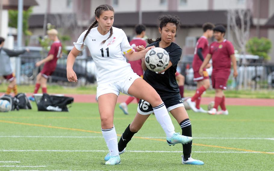 E.J. King’s Maliwan Schinker and Zama’s Minami Washington scuffle for the ball during Saturday’s DODEA-Japan girls soccer match. Schinker scored a hattrick and the Cobras won 4-0; she leads the Pacific with 38 goals this season.