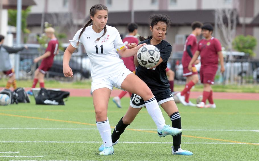 E.J. King’s Maliwan Schinker and Zama’s Minami Washington scuffle for the ball during Saturday’s DODEA-Japan girls soccer match. Schinker scored a hattrick and the Cobras won 4-0; she leads the Pacific with 38 goals this season.