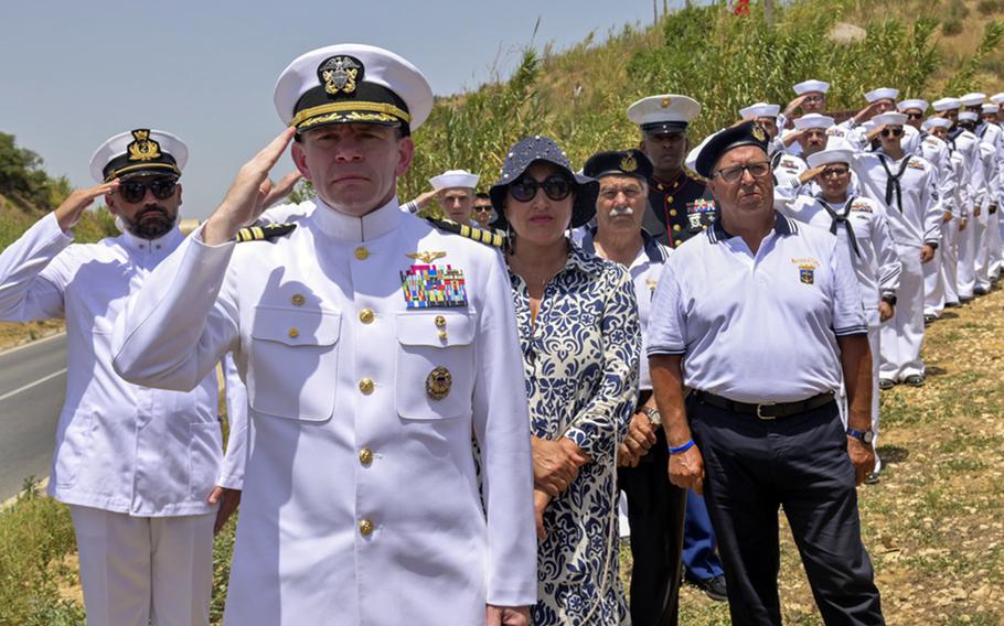 Capt. Aaron Shoemaker, commander of Naval Air Station Sigonella, salutes the ensign during the national anthem at an Operation Husky 80th anniversary commemoration ceremony, which took place at the 82nd Airborne Division Monument at Ponte Dirillo in Gela, Italy, July 10, 2023. Throughout Sicily in July, service members from the base are attending ceremonies to celebrate the 80th anniversary of the World War II Allied invasion of the island.