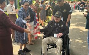 Veteran Charlie Baldwin beams as he passes a crowd of well-wishers from the Normandy commune of Houlgate, France, who turned out to greet veterans passing through on June 3, 2024, to attend the D-Day commemorations.