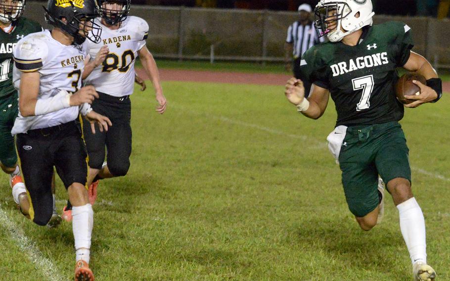 Kubasaki quarterback A.J. Millette tries to outrun Kadena's Anthony Chavez and Eric Puterbaugh.