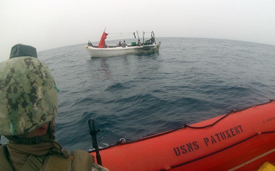 Sailors assigned to Embarked Security Intelligence Team 11, deployed with Commander, Task Force 56, and merchant mariners from the Military Sealift Command fleet replenishment oiler USNS Patuxent, approach a boat in distress during rescue operations in the Gulf of Aden, June 16, 2021. 