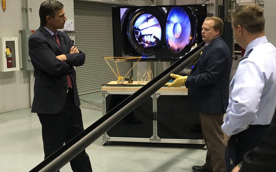 Dr. Andy Williams, center, Air Force Research Laboratory Deputy Technology Executive Officer for Space Science & Technology, explains the engineering of the Roll-Out-Solar Array, or ROSA, to U.S. Senator Martin Heinrich during a past visit to AFRL’s Space Vehicles Directorate at Kirtland Air Force Base, New Mexico.