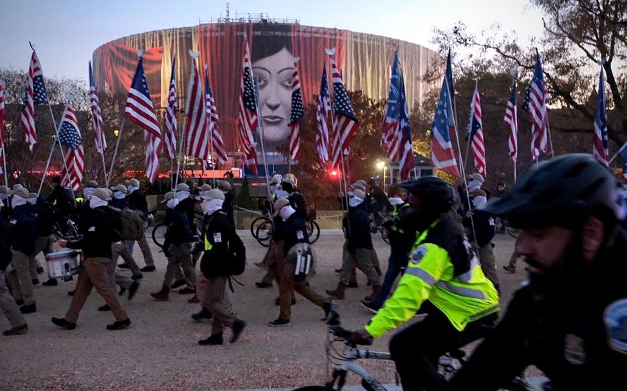 Members of the white nationalist group Patriot Front march down the National Mall on Dec. 4, 2021, in Washington. 