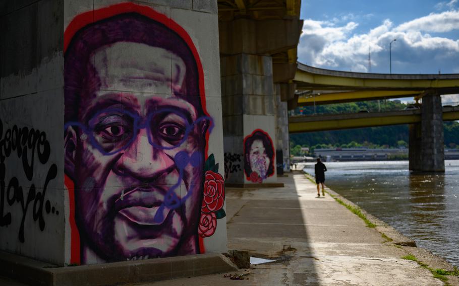 Memorial murals of George Floyd and Breonna Taylor beside the Allegheny River in Pittsburgh. 