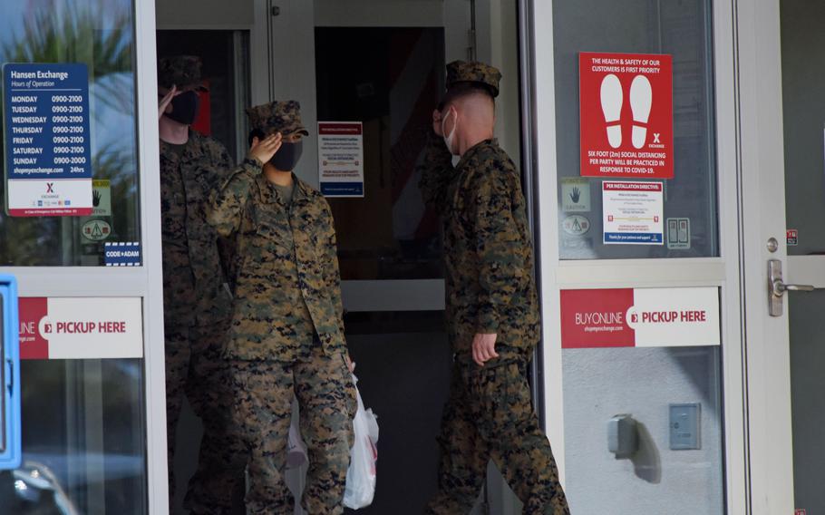 Marines enter and exit an exchange store at Camp Hansen, Okinawa, Dec. 20, 2021. 
