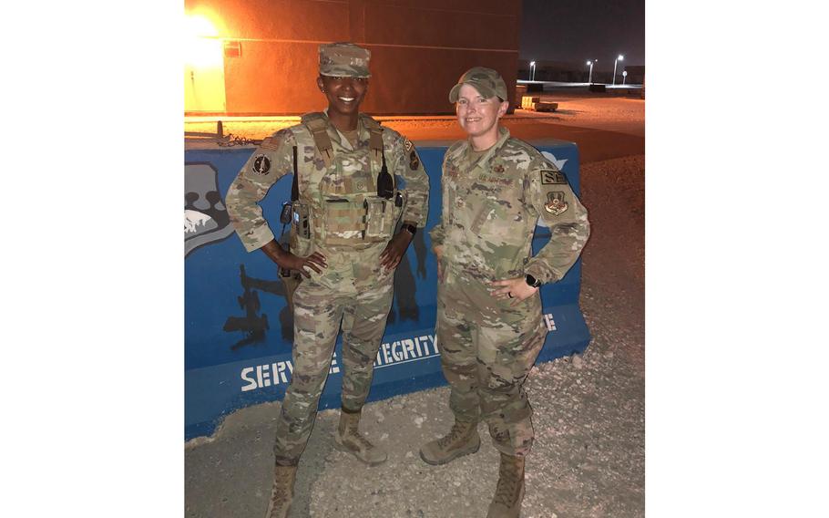 Senior Master Sgt. Megan Harper, right, and another airman pose for a photo during Operation Allies Refuge, an airlift to evacuate certain at-risk Afghan civilians from Afghanistan in August last year. Harper served as operations superintendent of the 379th Security Forces Squadron at Al Udeid Air Base during the evacuation. 