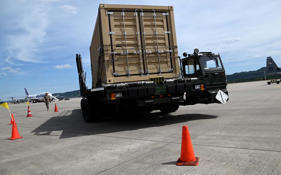 A member of the 728th Air Mobility Squadron team from Incirlik, Air Base, Turkey, maneuvers a Tunner 60K aircraft cargo loader through a winding course at the Port Dawg Rodeo at Ramstein Air Base, Germany, July 6, 2022.