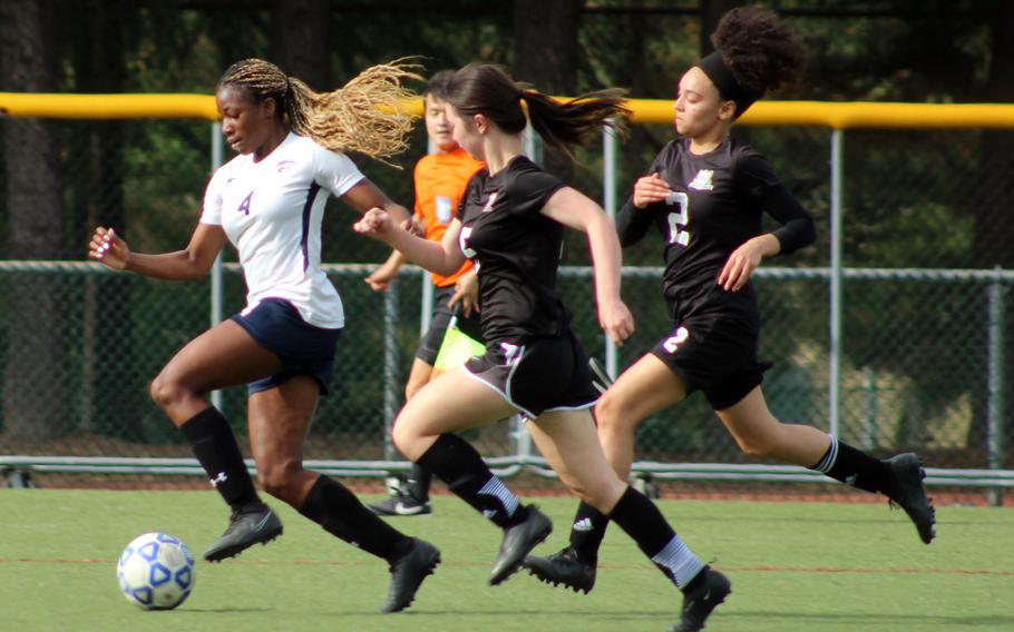 Osan’s Tatiana Lunn races upfield with the ball with Daegu defenders in her wake during Friday’s DODEA-Korea girls soccer match. Lunn scored twice and the Cougars won 3-0.