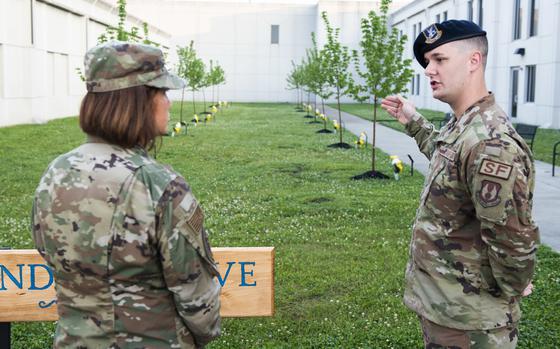 Chief Master Sergeant of the Air Force JoAnne S. Bass is briefed by Senior Airman Mark Debats of the 88th Security Forces Squadron on the unit’s Defenders Grove upon her arrival at the unit June 4, 2021, as part of a multiday tour of Wright-Patterson Air Force Base, Ohio. Defenders Grove, which honors fallen Security Forces Airmen lost since 9/11, was dedicated at WPAFB last October. The tour brought Bass to several units within the 88th Air Base Wing, Air Force Materiel Command, Air Force Life Cycle Management Center and Air Force Research Laboratory. (U.S. Air Force photo by Wesley Farnsworth)