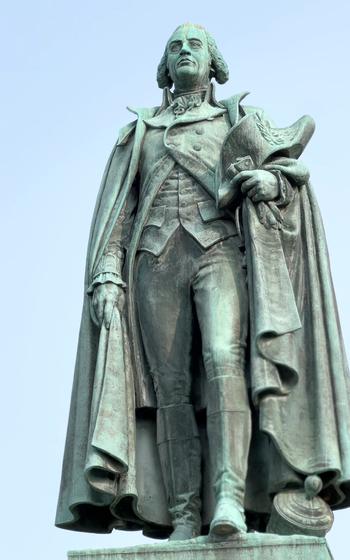 A statue of Ward, with cape and hat in hand.