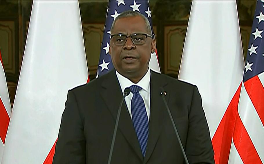 U.S. Defense Secretary Lloyd Austin speaks to reporters during a joint press conference with Polish Defense Minister Mariusz Blaszczak in Warsaw, Feb. 18, 2022. Austin was to  meet later with service members deployed to Poland.