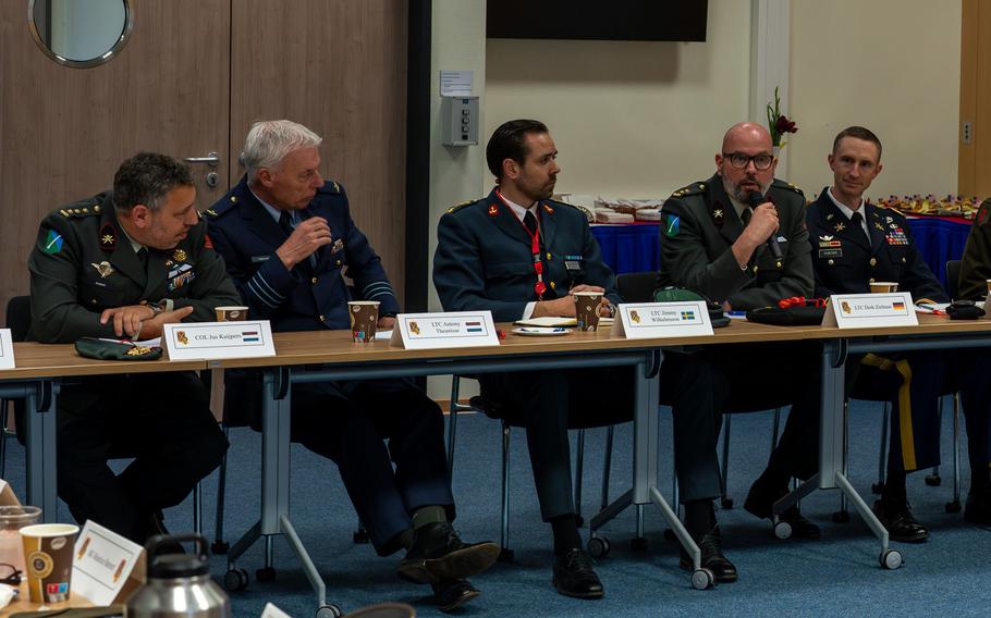 Col. Jus Kuijpers, from left, and Lt. Col. Antony Theunisse of the Netherlands military and Lt. Col. Jimmy Wilhelmsson of the Swedish military, listen to Lt. Col. Derk Zielman of the German military speak during a closed-door NATO meeting on air defense on Sembach Kaserne, Tuesday, April 9, 2024.