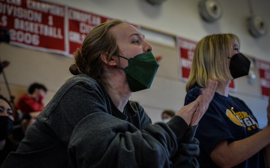 Family members cheer on their players during the DODEA-Europe Division III girls basketball title game in Kaiserslautern, Germany, on Saturday, Feb. 26, 2022.