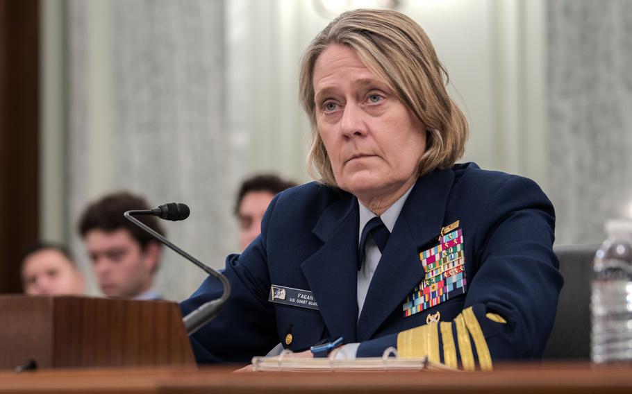 Adm. Fagan in full uniform faces questions.