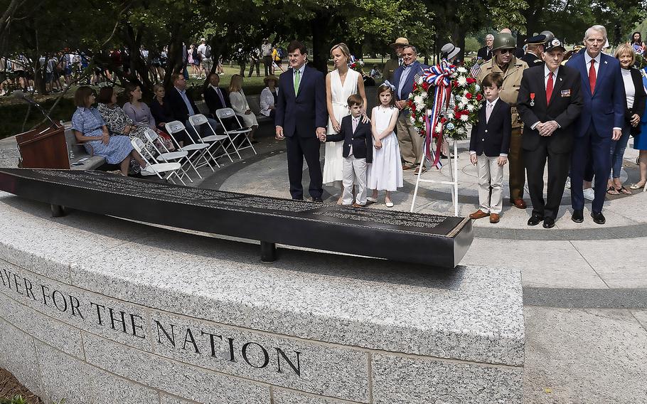 Roosevelt family members and other dignitaries listen to the playing of service songs by the U.S. Army Brass Quintet at the National World War II Memorial in Washington, D.C., on the 79th anniversary of the start of the D-Day invasion, Tuesday, June 6, 2023.