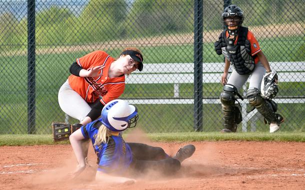 Sigonella's Alice Lefringhouse slides under the tag by Sentinel pitcher Riley Lombardo during an April 27, 2024, game at Spangdahlem High School in Spangdahlem, Germany.