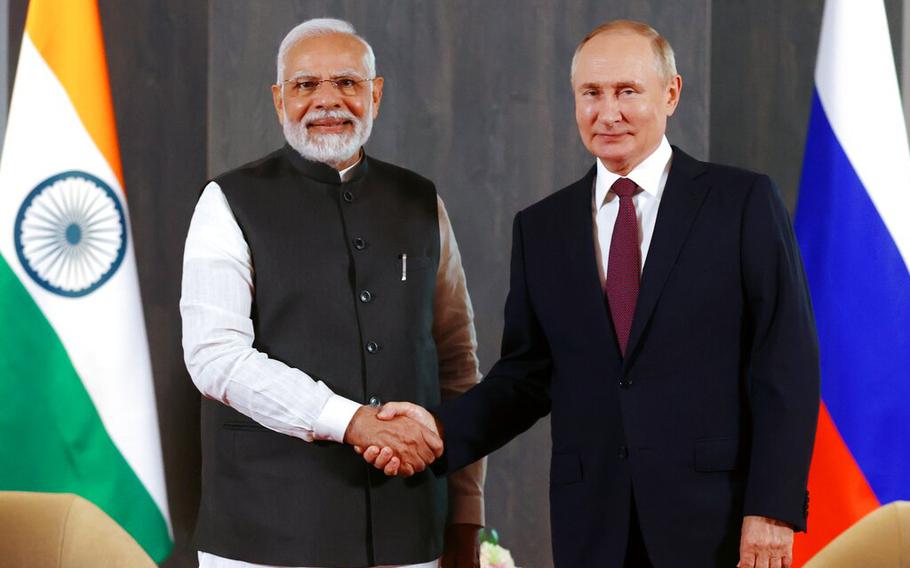 Russian President Vladimir Putin, right, and Indian Prime Minister Narendra Modi shake hands prior to their talks on the sidelines of the Shanghai Cooperation Organisation summit in Samarkand, Uzbekistan, on Friday, Sept. 16, 2022.